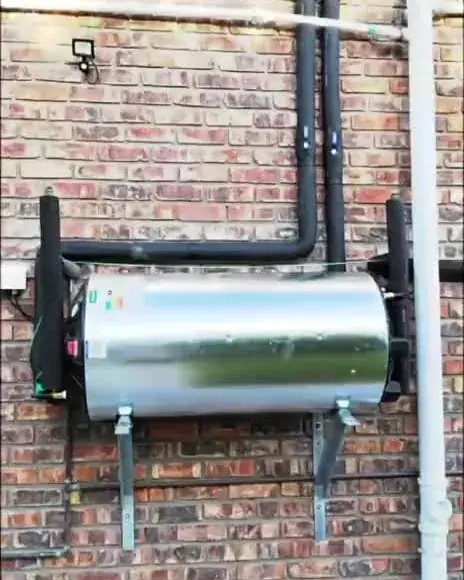Geyser and pipework installed on an outside brick wall
