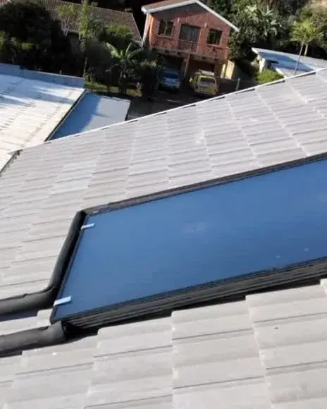 Solar geyser collector panels installed on a tiled roof in Cape Town